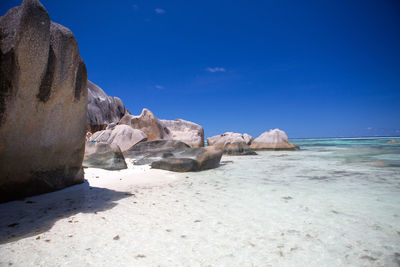 Scenic view of beach against blue sky