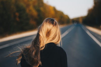 Rear view of woman on road