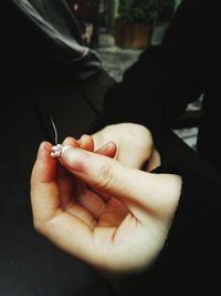 Close-up of hands holding jewelry