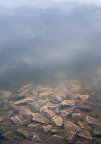 High angle view of rocks in water against sky