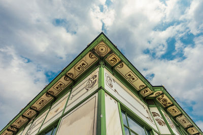 Low angle view of text on building against sky