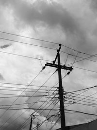 Low angle view of electricity pylon against sky