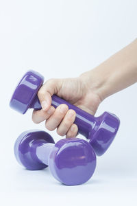 Close-up of hands over white background