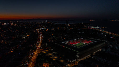 High angle view of illuminated city buildings at night