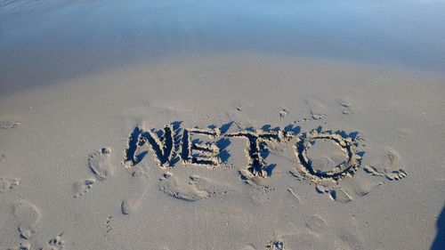 High angle view of text written on sand at beach