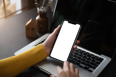 Midsection of woman using mobile phone