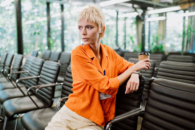 Portrait of young woman sitting on bench