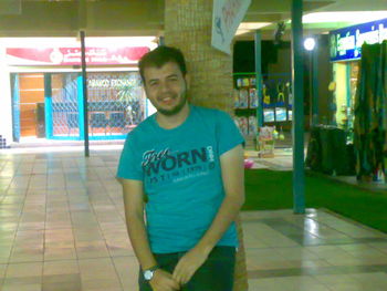 Portrait of smiling young man standing at night