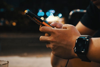 Close-up of man using mobile phone