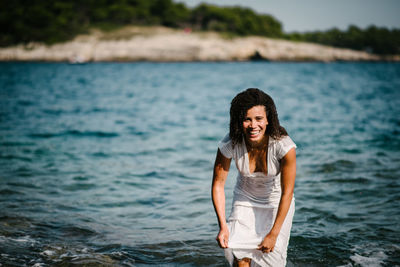 Portrait of smiling young woman in sea