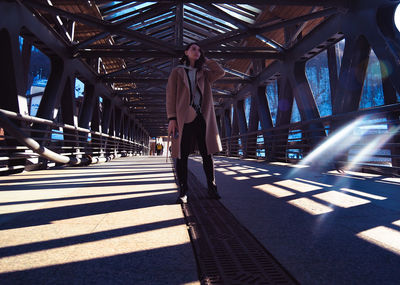 Low angle view of man walking on bridge