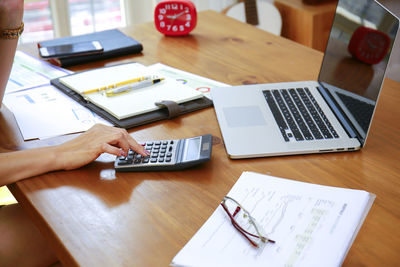 High angle view of woman using laptop on table