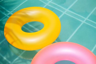 High angle view of inflatable rings floating on swimming pool