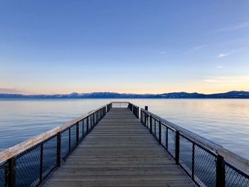 Pier over lake against sky