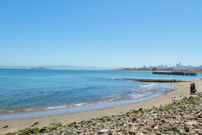 Scenic view of sea against clear blue sky