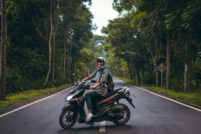 Man riding motorcycle on road