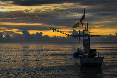 Sailboat in sea against sky during sunset