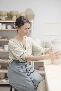 Owner working in pottery store