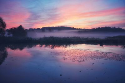 Scenic view of lake against sky during sunset