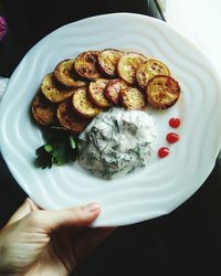 Cropped image of hand holding food