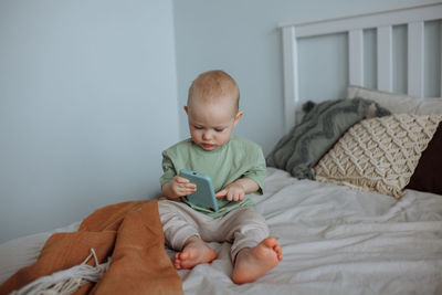 Portrait of cute baby boy sleeping on bed at home