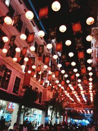 Low angle view of illuminated lights at night