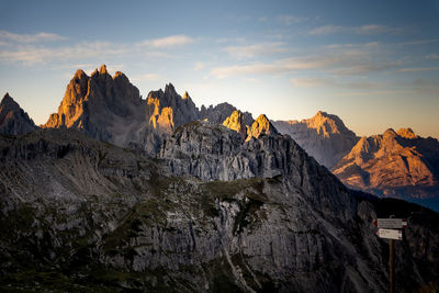 Panoramic view of rocky mountains against sky during sunset