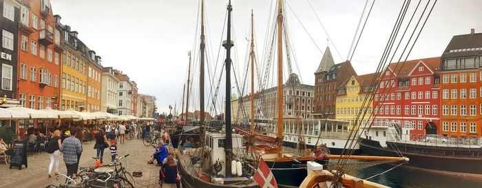 Panoramic view of people in city against sky