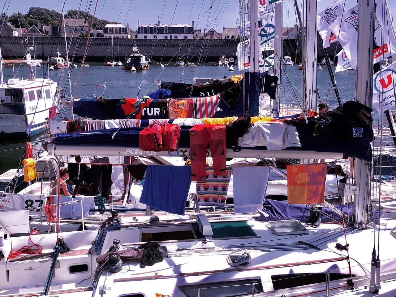 SAILBOATS MOORED IN HARBOR