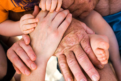 Cropped image of baby holding hands