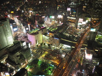 High angle view of city lit up at night