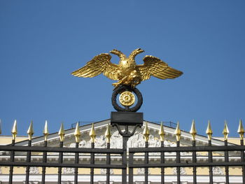 Low angle view of sculpture against blue sky