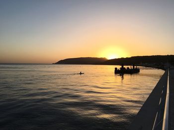 Scenic view of sea against clear sky during sunset