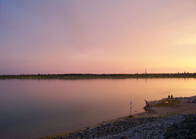 Scenic view of lake against sky during sunset