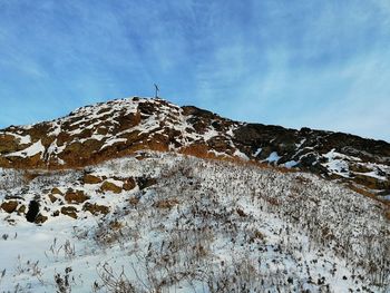 Low angle view of snowcapped mountain against sky