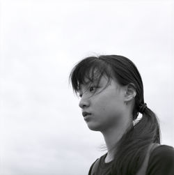 Close-up of girl against clear sky