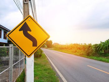 Road sign against sky