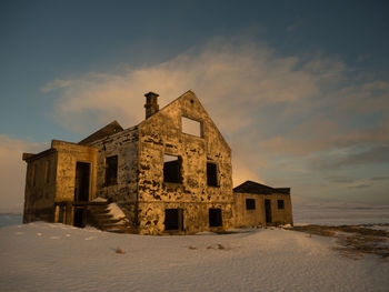 Exterior of historic building against sky during winter