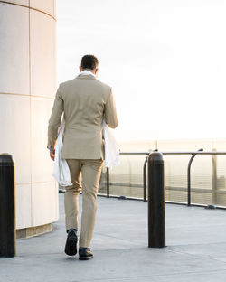 Rear view of a man walking rooftop