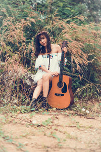 Woman sitting guitar