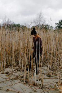 Man standing on field against sky