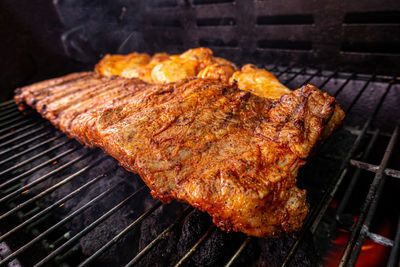 High angle view of meat on barbecue grill