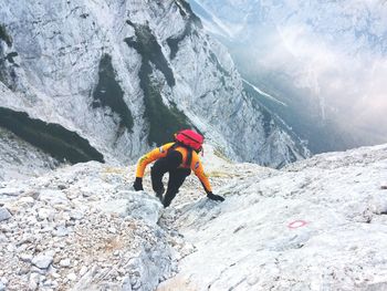 High angle view of person climbing on rocky mountain