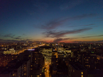 Illuminated cityscape against sky