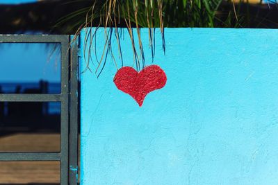 Close-up of heart shape on blue wall