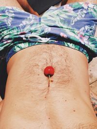 Close-up of hand holding red rose