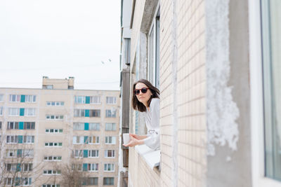 Portrait of woman looking out of window