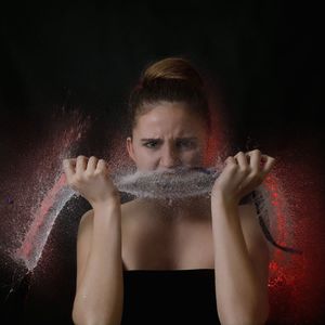 Woman popping water balloon