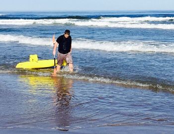 Full length of man on beach against sky