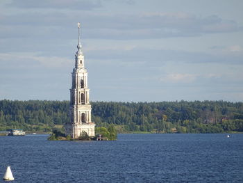 View of building by sea against sky